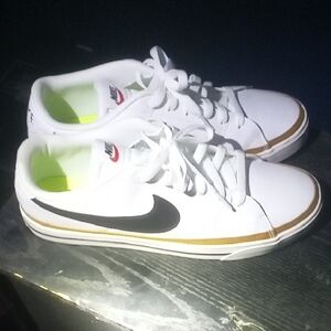 Nike White Sneakers with Black Swoosh and Gold Trim